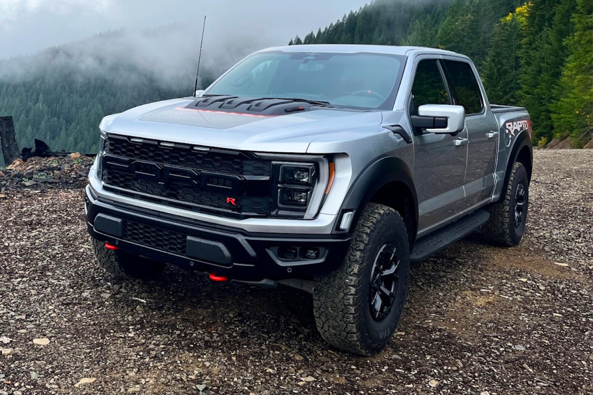 Black Ford F 150 Raptor driving through a desert trail